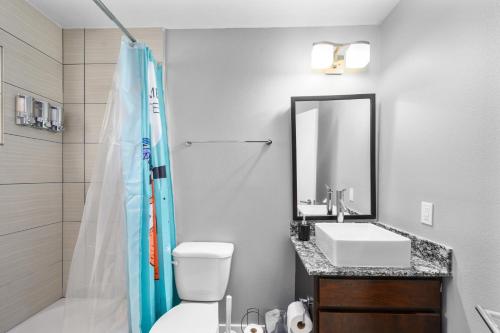 a bathroom with a shower and a toilet and a sink at 1-Bedroom Haven in Murworth, Close to Medical Center in Houston