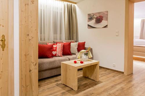 a living room with a couch and a table at Hotel Bergkristall in Silbertal