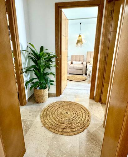 a living room with a rug on the floor at Appart avec piscine commune à Hammamet 5min de la plage in Hammamet Nord