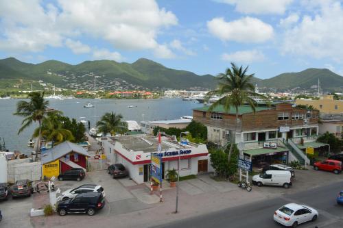 a city with a harbor and a town with cars parked at Travel Inn Hotel Simpson Bay in Simpson Bay