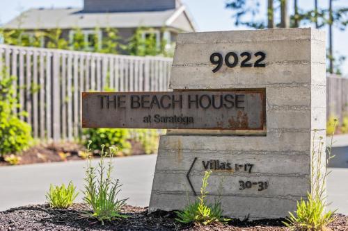 a sign that says the beach house at sanctuary at Ocean View Townhouse #27 in Oyster Bay