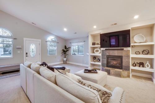 a living room with a couch and a fireplace at Near Red Rocks Golden Getaway with Deck! in Golden
