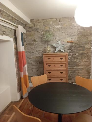 a dining room with a black table and chairs at Stay in Annascaul Village at Aido's in Annascaul