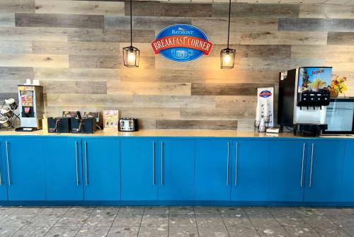 a counter in a fast food restaurant with blue cabinets at Baymont by Wyndham Keokuk in Keokuk