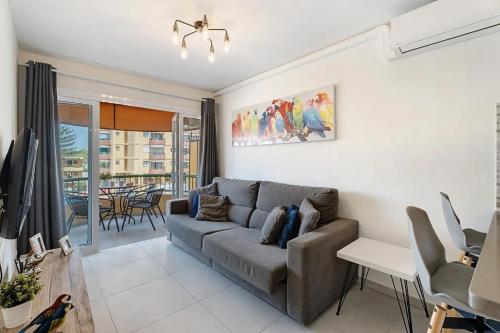 a living room with a couch and a table at Luxury & Comfort en Torre del Sol, Playa de las Américas in Arona