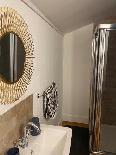 a bathroom with a sink and a mirror at Stay in Annascaul Village at Aido's in Annascaul