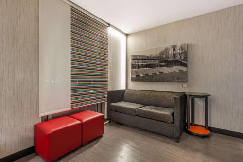 a living room with a couch and a red stool at Vīb Best Western Springfield in Springfield