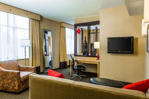 a hotel room with a couch and a desk at Cambria Hotel Raleigh-Durham Airport in Morrisville