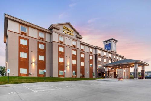 a hotel building with a parking lot in front of it at Sleep Inn & Suites Lincoln University Area in Lincoln