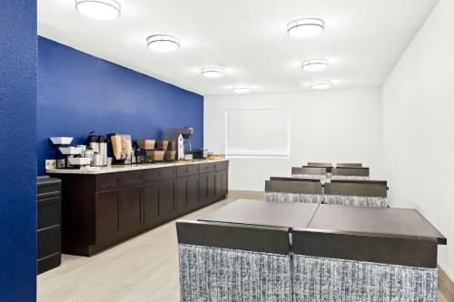 a kitchen with blue walls and aasteryasteryasteryasteryasteryasteryasteryasteryastery at SureStay Hotel by Best Western Groves in Groves