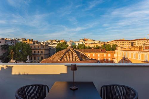 a view of a city from a balcony with a table and chairs at Hotel Raffaello - Sure Hotel Collection by Best Western in Rome