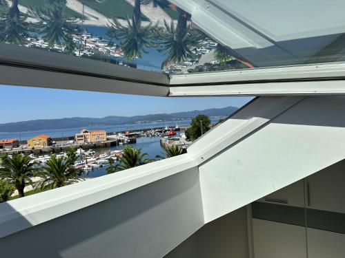 a view of the marina from the balcony of a building at Ático mirando o mar in Porto do Son