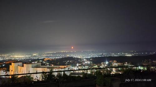 a view of a city at night at Rooms by Lion in Krujë