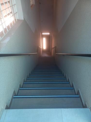 a staircase in an empty building with a light at the top at Teixeira in Olímpia