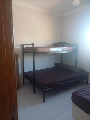 a bedroom with two bunk beds in a room at Teixeira in Olímpia