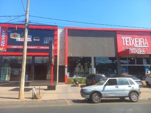 a car parked in front of a store at Teixeira in Olímpia