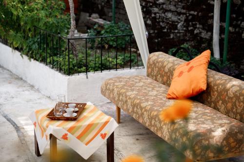a couch sitting on a patio with a coffee table at GuestHouse Te Bregu in Gjirokastër