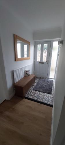 a room with a door with a couch and a window at Willow Cottage 3 bed, cosy stopover, dogs welcome in Thornton-le-Beans