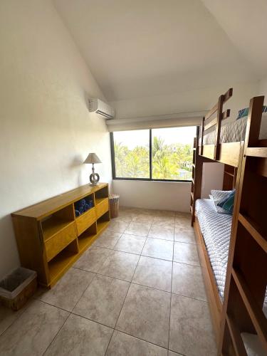 a bedroom with bunk beds and a large window at Villa in Monterrico in El Garitón