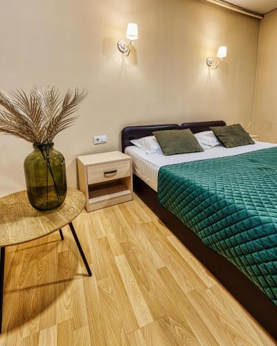 a bedroom with two beds and a vase with a plant at SV Hotel, Restaurant & Airport Parking in Todoreshty