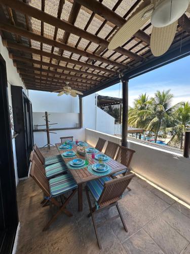 a table and chairs on a patio with a view of the ocean at Villa in Monterrico in El Garitón