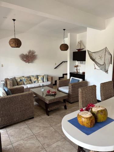a living room with couches and a table at Villa in Monterrico in El Garitón