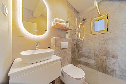 a bathroom with a sink and a toilet and a mirror at Apartments by the sea Prizba, Korcula - 22068 in Blato