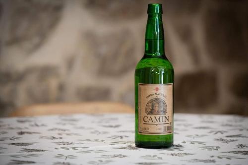 a green bottle of wine sitting on a table at La Casona de Obdulia II in Tresgrandas