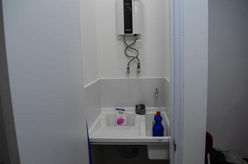 a bathroom with a sink in a white room at Apartamento en el centro Bogotá in Bogotá