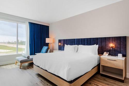 a bedroom with a large bed and a large window at EVEN Hotel Waco - University Area by IHG in Waco