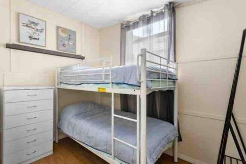 a bedroom with two bunk beds and a window at Bayside Living - Walk to Water - Central location in Deception Bay