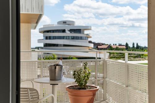 a balcony with a table and a plant at voco Beaune , Cité des Vins by IHG in Beaune