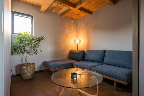 a living room with a couch and a table at HOTEL Sauna&Living in Iwanuma