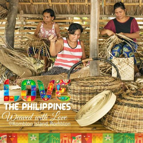 a group of people sitting in a hut with baskets at TST Transient Home - WiFi Access, Kitchenette, Private Bathroom in Romblon