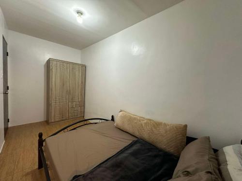a living room with a couch and a window at Entire Townhouse - SANTO TOMAS BATANGAS in Santo Tomas