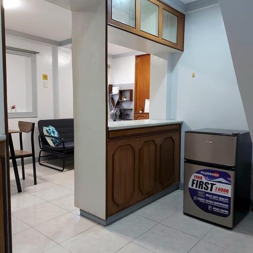 a kitchen with a trash can next to a counter at TST Transient Home - WiFi Access, Kitchenette, Private Bathroom in Romblon