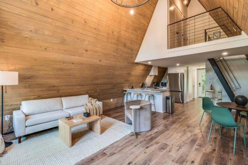 a living room with a couch and a table at Modern A-Frame Cabin by Rip Van Winkle with Hot Tub in New Iberia