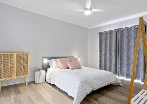 ポート・エリオットにあるNest 6 Battunga Ave Port Elliot - No Linen Includedのベッドと窓のある白い寝室