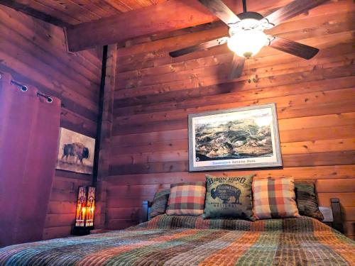 a bedroom with a bed in a wooden wall at Cozy Copper Cabin Lodge in Sioux Falls