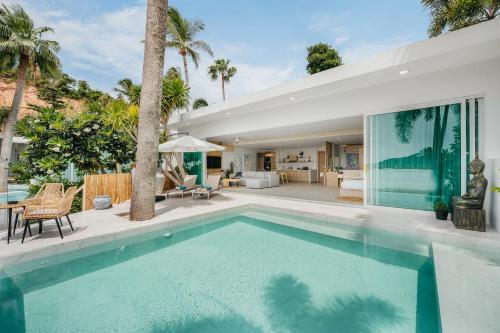 a swimming pool in the backyard of a house at Bangrak Beachfront "Secret Tides" Villas in Bangrak Beach