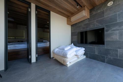 a bedroom with a fireplace and a flat screen tv at akesuke in Minamiawaji