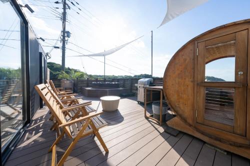 a deck with two chairs and a desk on a boat at akesuke in Minamiawaji