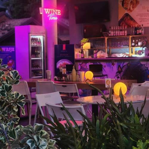 a room with tables and chairs with purple lights at Studio Seaview Jomtien floor12 23sqm in Jomtien Beach