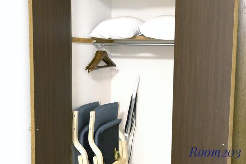 a closet with blue chairs on a shelf at SLEEPLAB THE STAY Casual 西新宿 in Tokyo