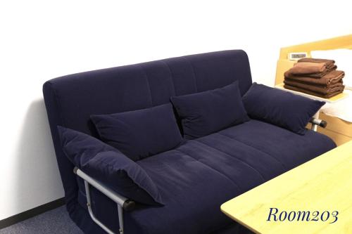 a blue couch with blue pillows in a room at SLEEPLAB THE STAY Casual 西新宿 in Tokyo