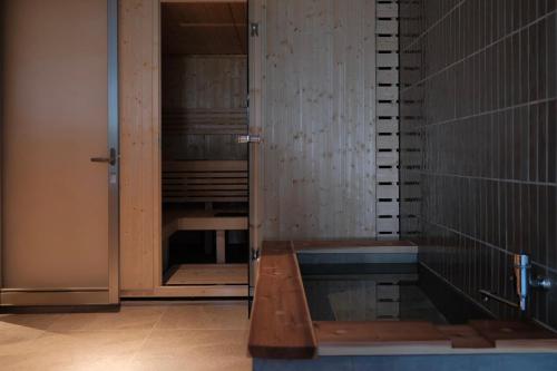 an empty shower in a room with a glass door at 清風荘 in Kosai