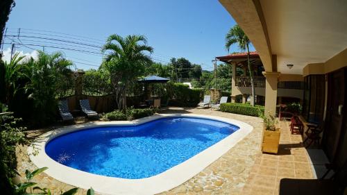 a swimming pool in the backyard of a house at Villas Welcome to Heaven in Carrillo