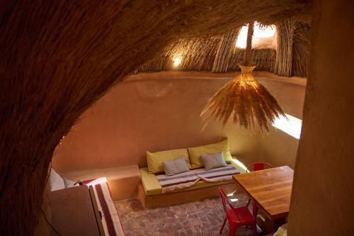 a living room with a couch and a table at Casa Jardín in San Pedro de Atacama