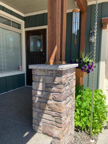 a stone fire pit outside of a house at Upper Room in the Mission in Kelowna