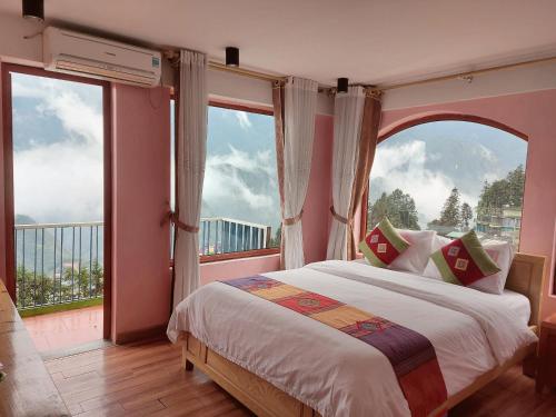 a bedroom with a bed with a large window at Sapa Scenery Hotel in Sapa